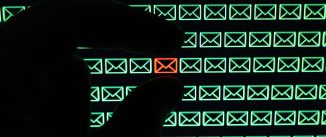 Shadow hand selecting red email icon from a field of green email icons.